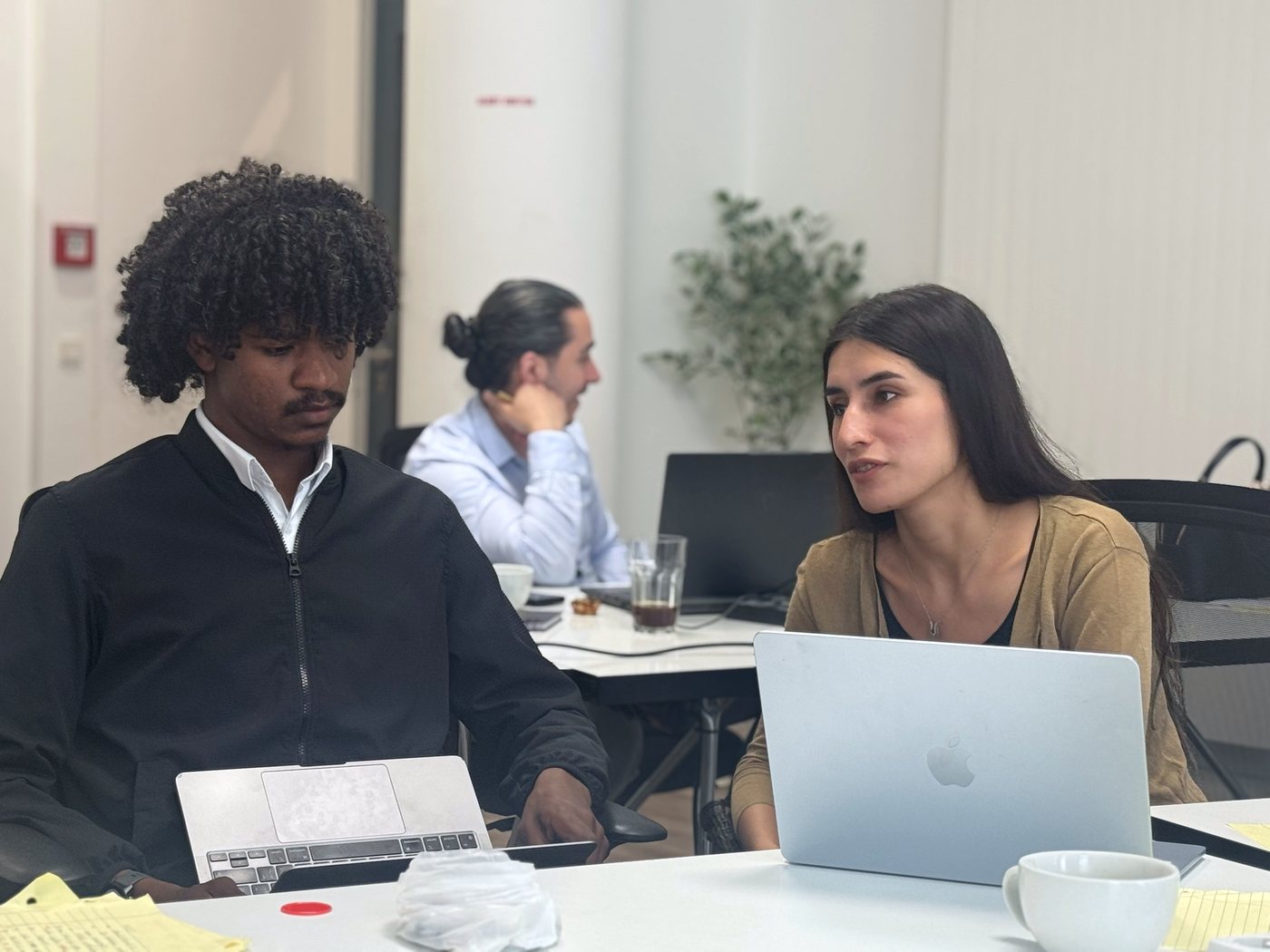Two founders working side by side on laptops during accelerator week