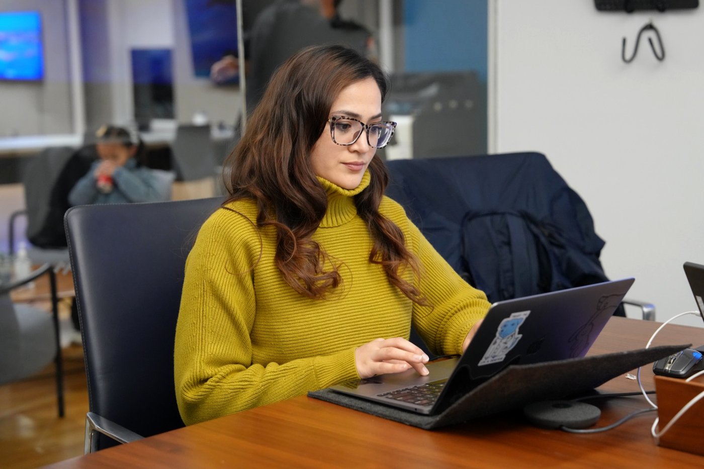 A founder working through the bootcamp material on her laptop